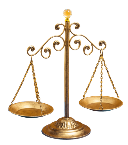 Gold balance scale on a decorative stand with two hanging pans