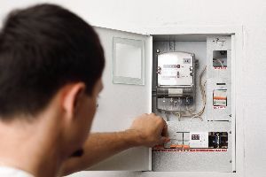 Man Checking the Electric Control Box — Nicholasville, KY — Stewart Air Conditioning & Heating Man Checking the Electric Control Box — Nicholasville, KY — Stewart Air Conditioning & Heating