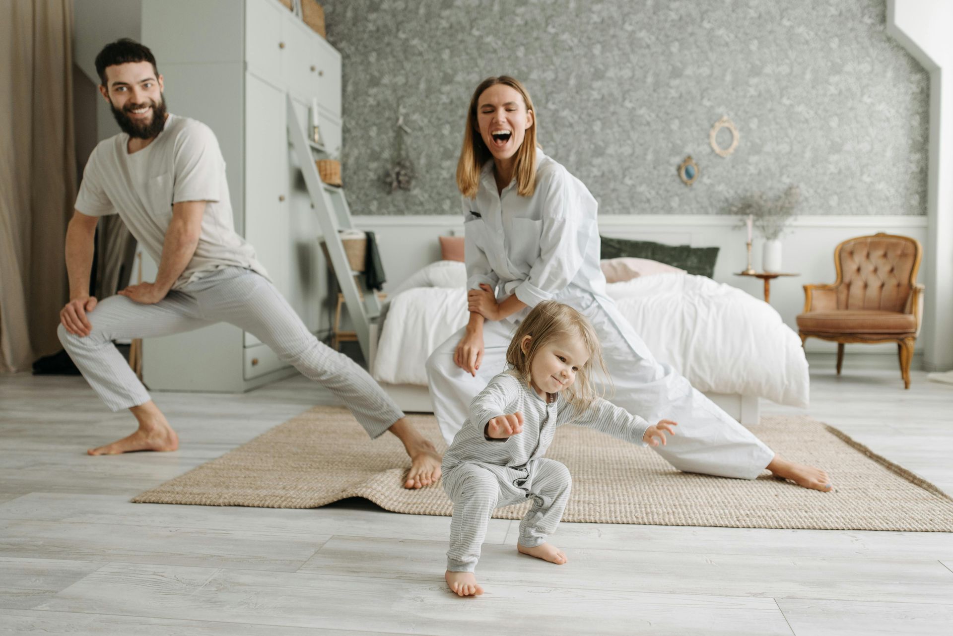 family doing cardio warm up with a personal trainer in their house