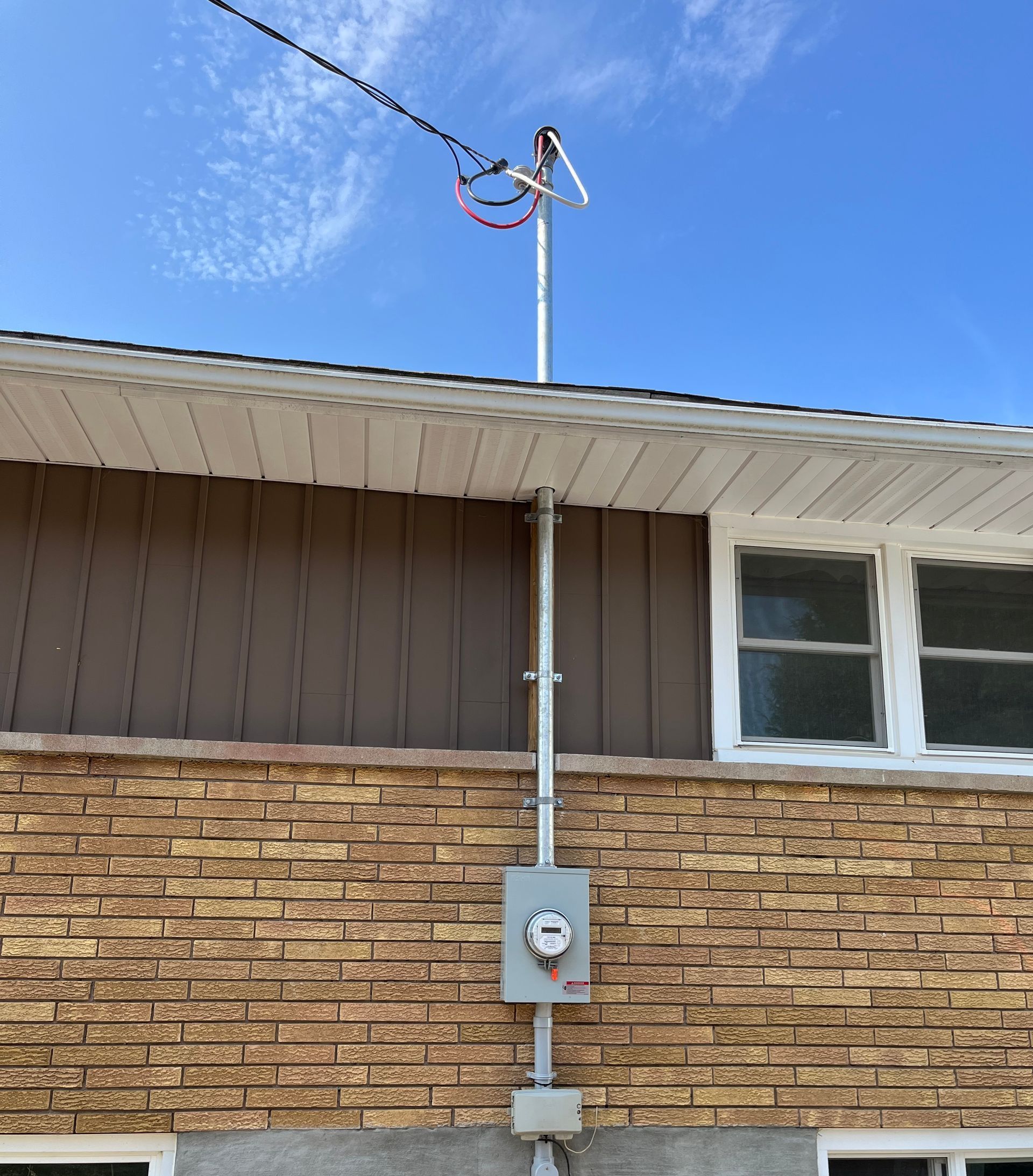 A brick building with an antenna on top of it