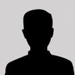 A silhouette of a man without a face on a gray background.