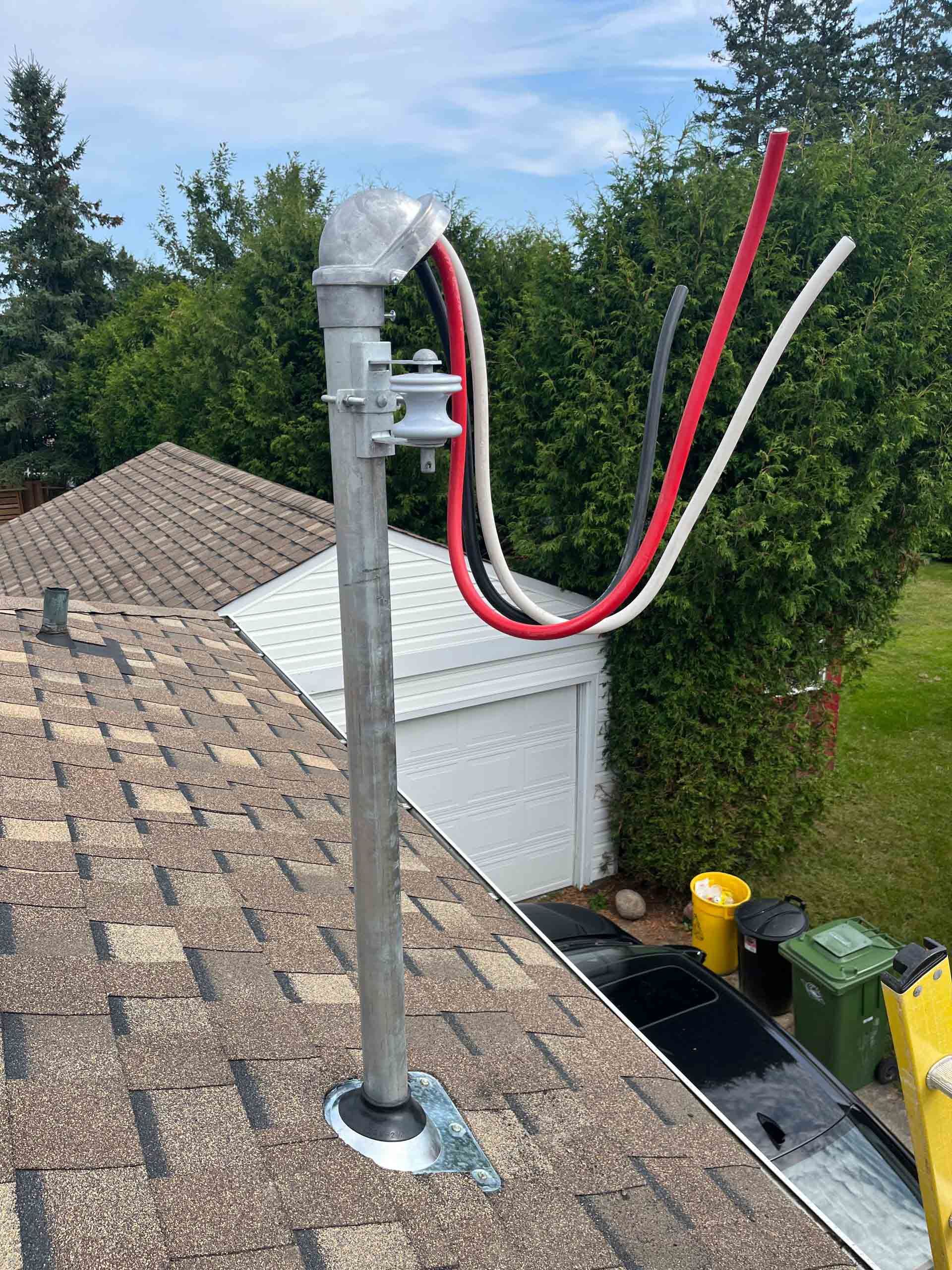 White Generac generator installed on a wooden base against a brick house