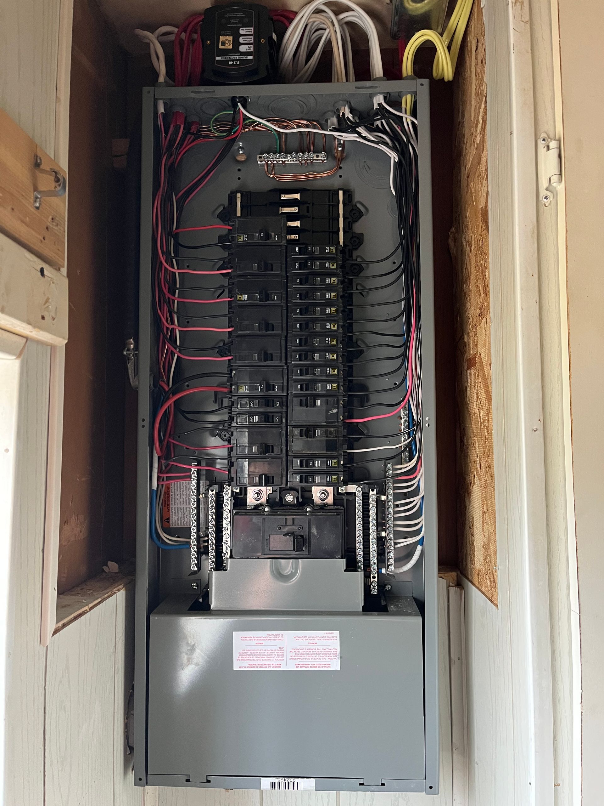 A large electrical box is hanging on a wall.