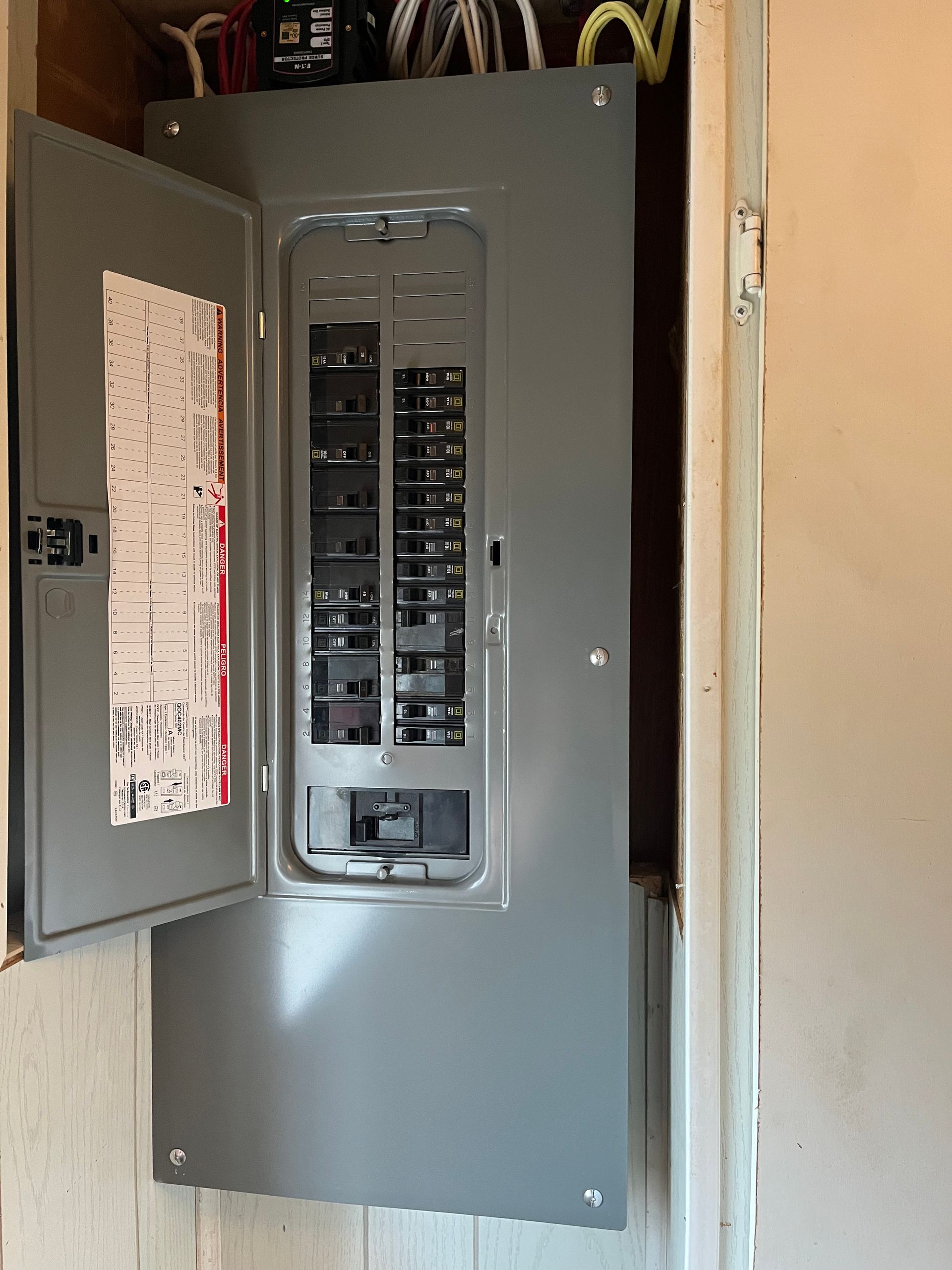 A gray electrical box with the door open in a room.
