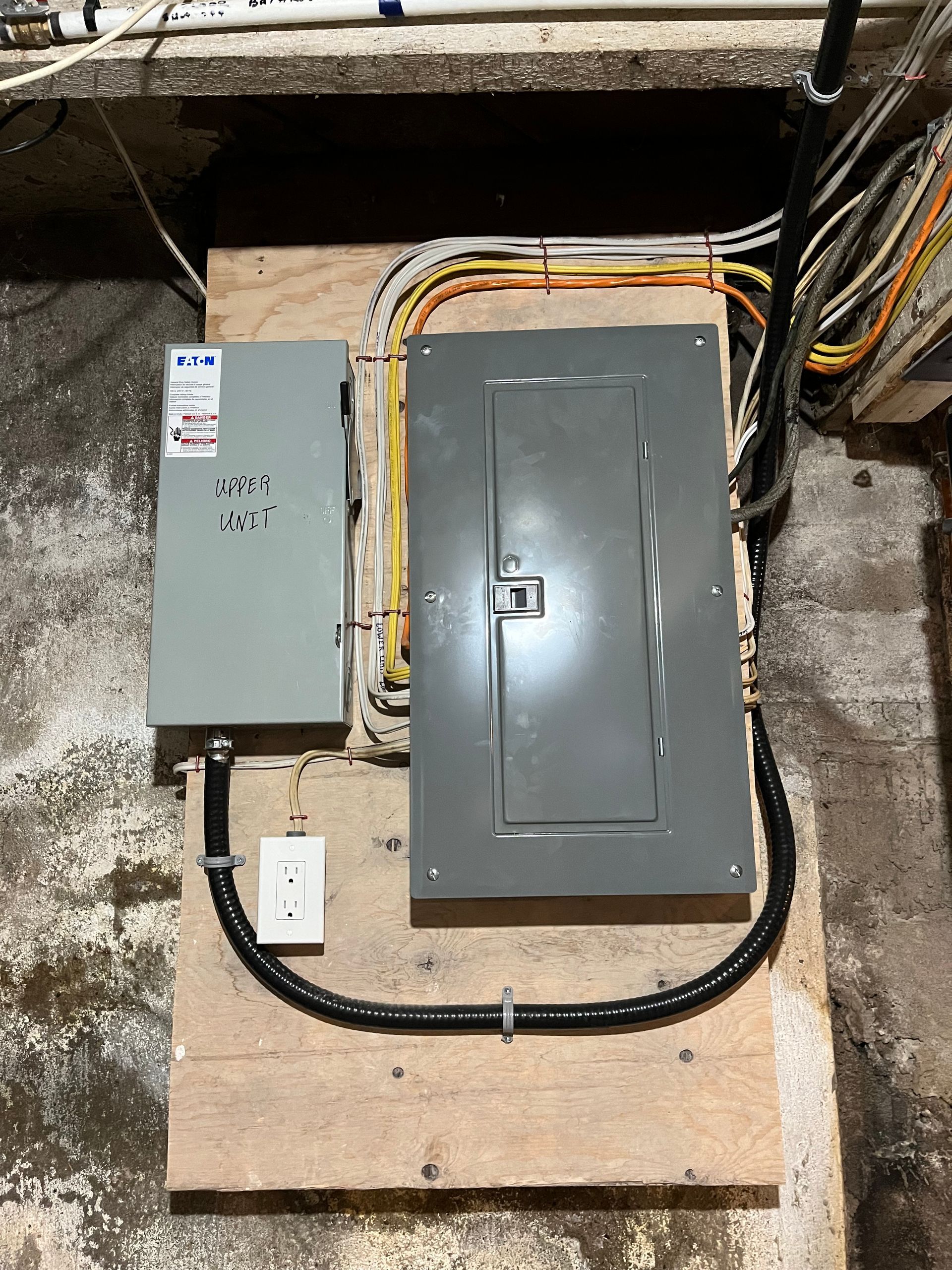 A electrical box is sitting on top of a wooden table.