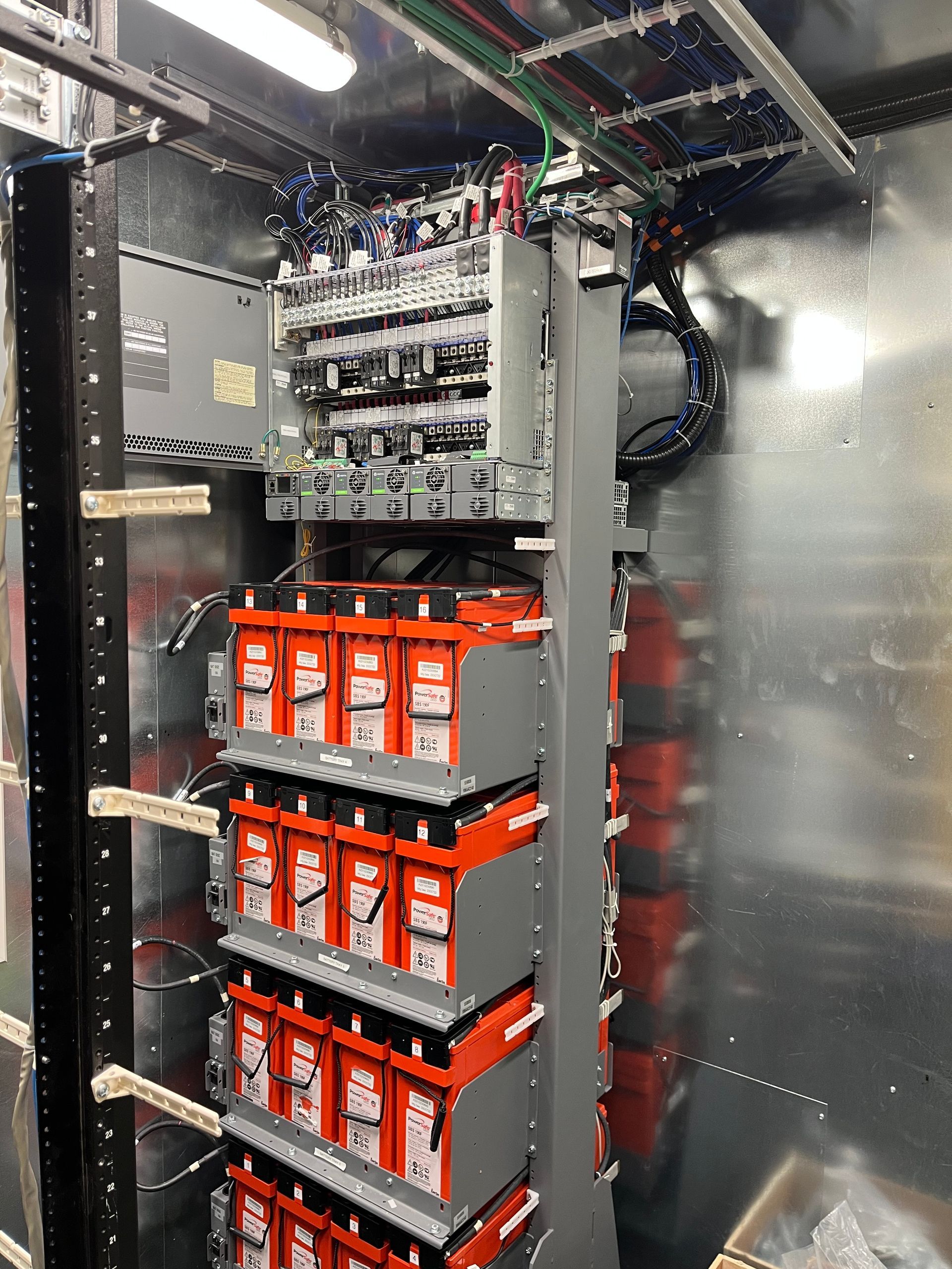 A bunch of batteries are stacked on top of each other in a room.