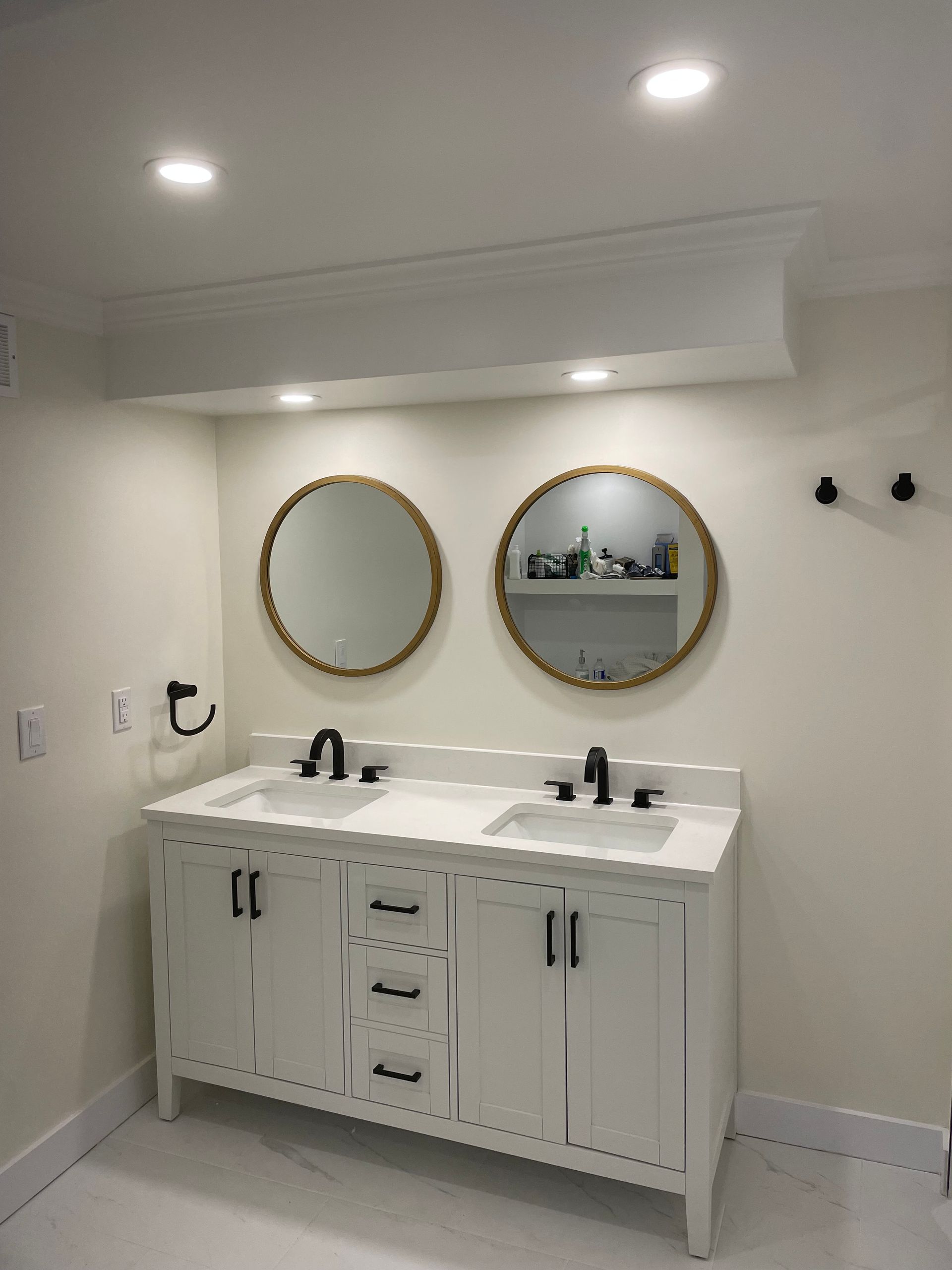 A bathroom with two sinks and two mirrors.