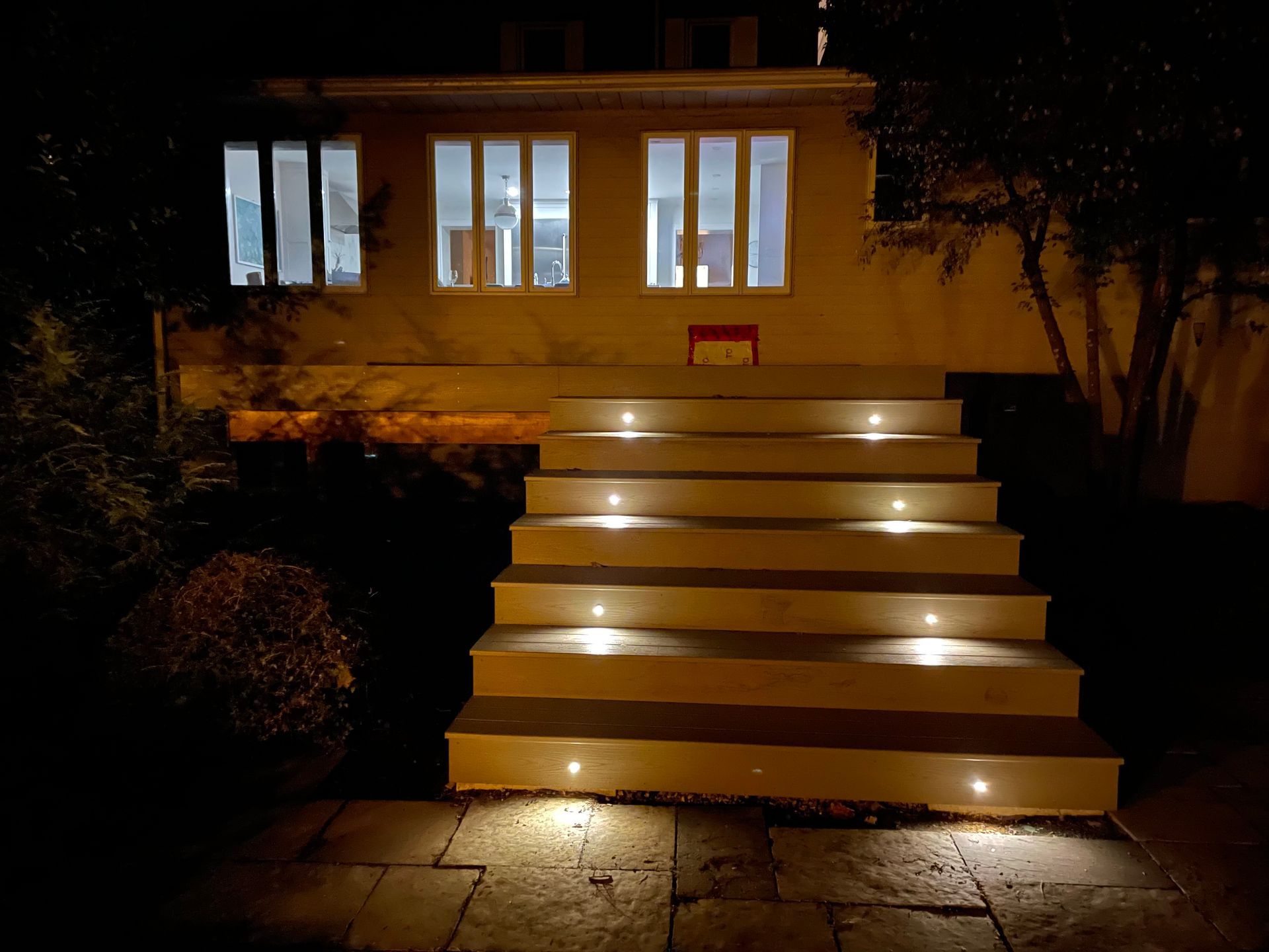 A set of stairs leading up to a house at night.