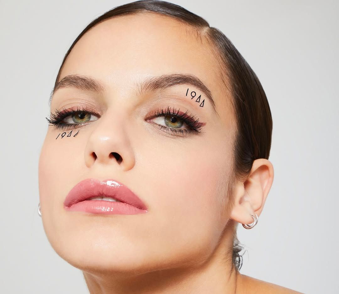 Un gros plan du visage d'une femme avec un tatouage sur le front