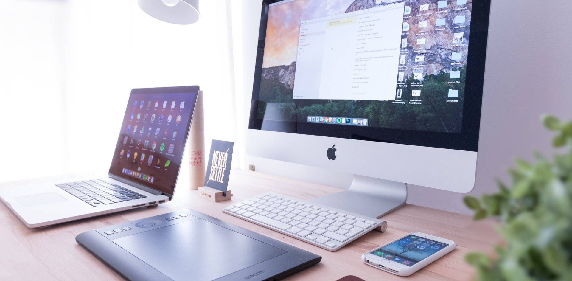 A desk with a laptop and a computer on it.
