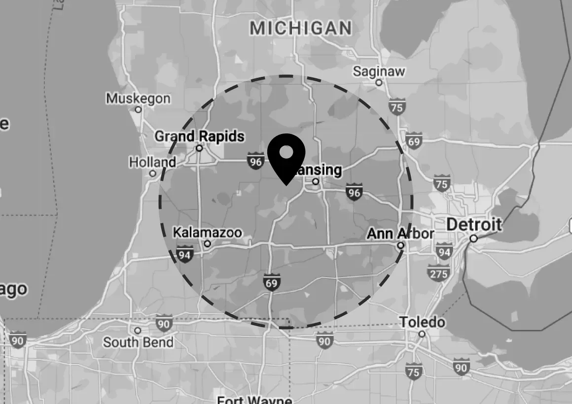 A black and white map of michigan with a pin pointing to grand rapids.