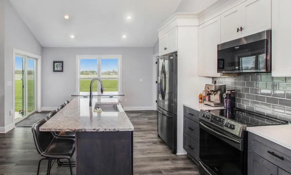 A kitchen with stainless steel appliances and granite counter tops.