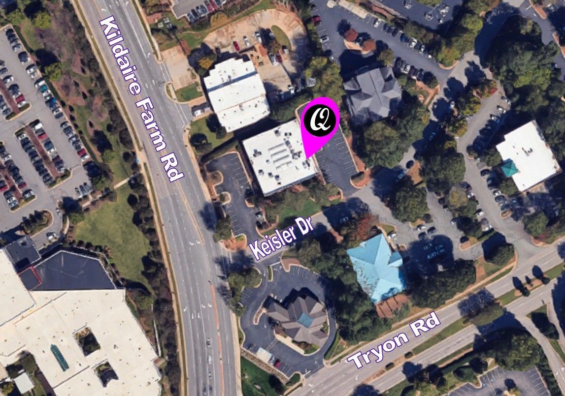 An aerial view of a residential area with a pink circle in the middle