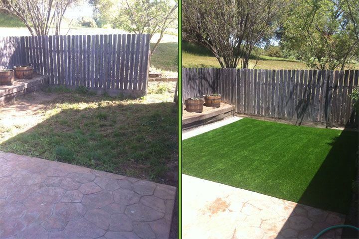 Backyard with a wooden fence, patio, and newly laid green lawn in bright sunlight