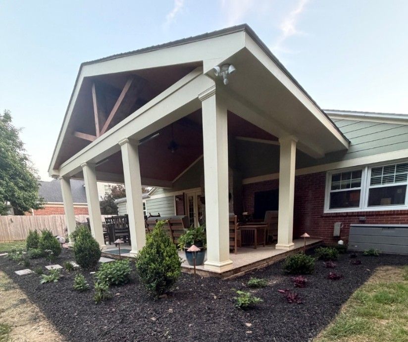 Covered outdoor patio addition on a brick home in Anniston, AL, featuring a gabled roof with exposed