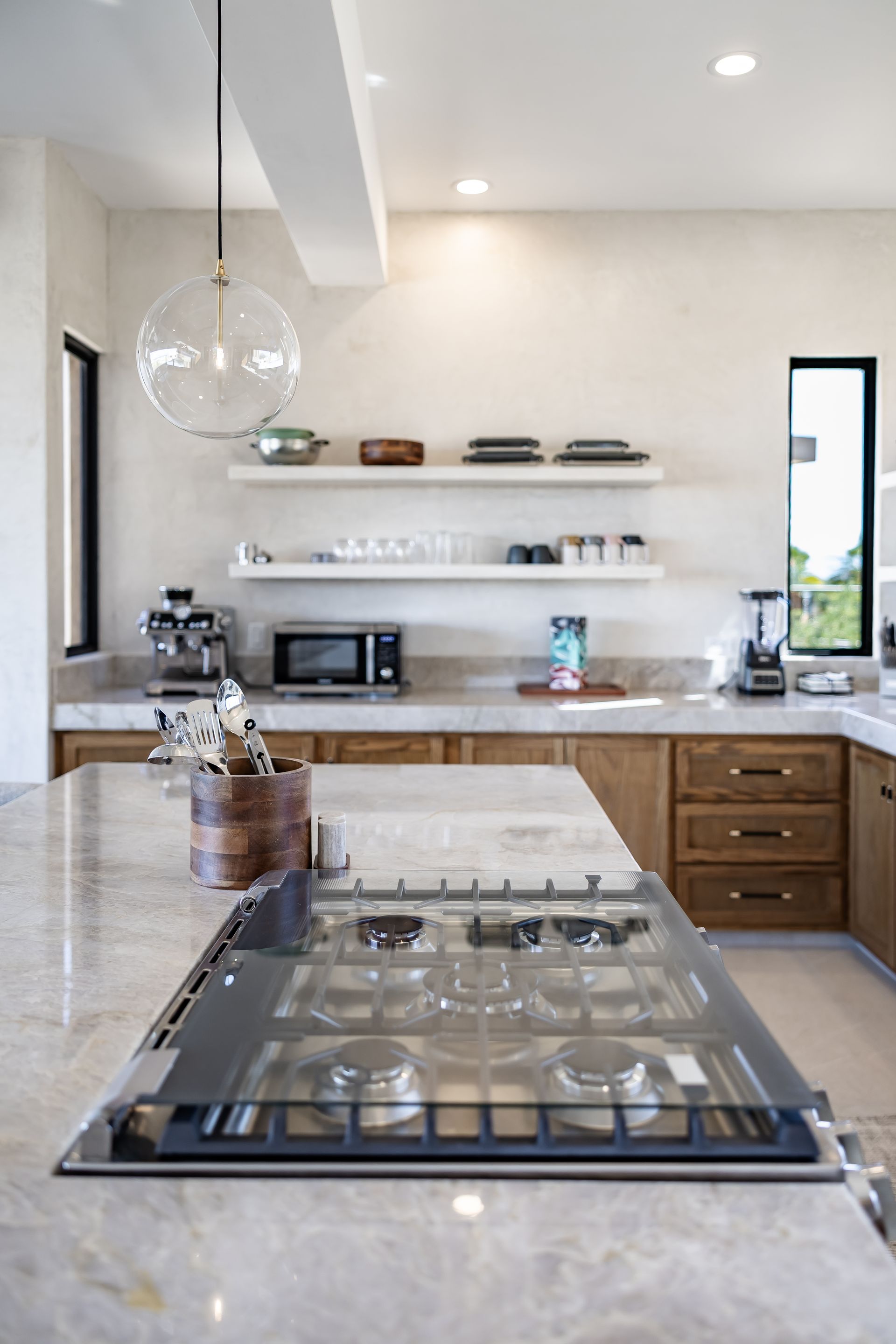Elegant open-concept kitchen with modern lighting and luxury finishes.