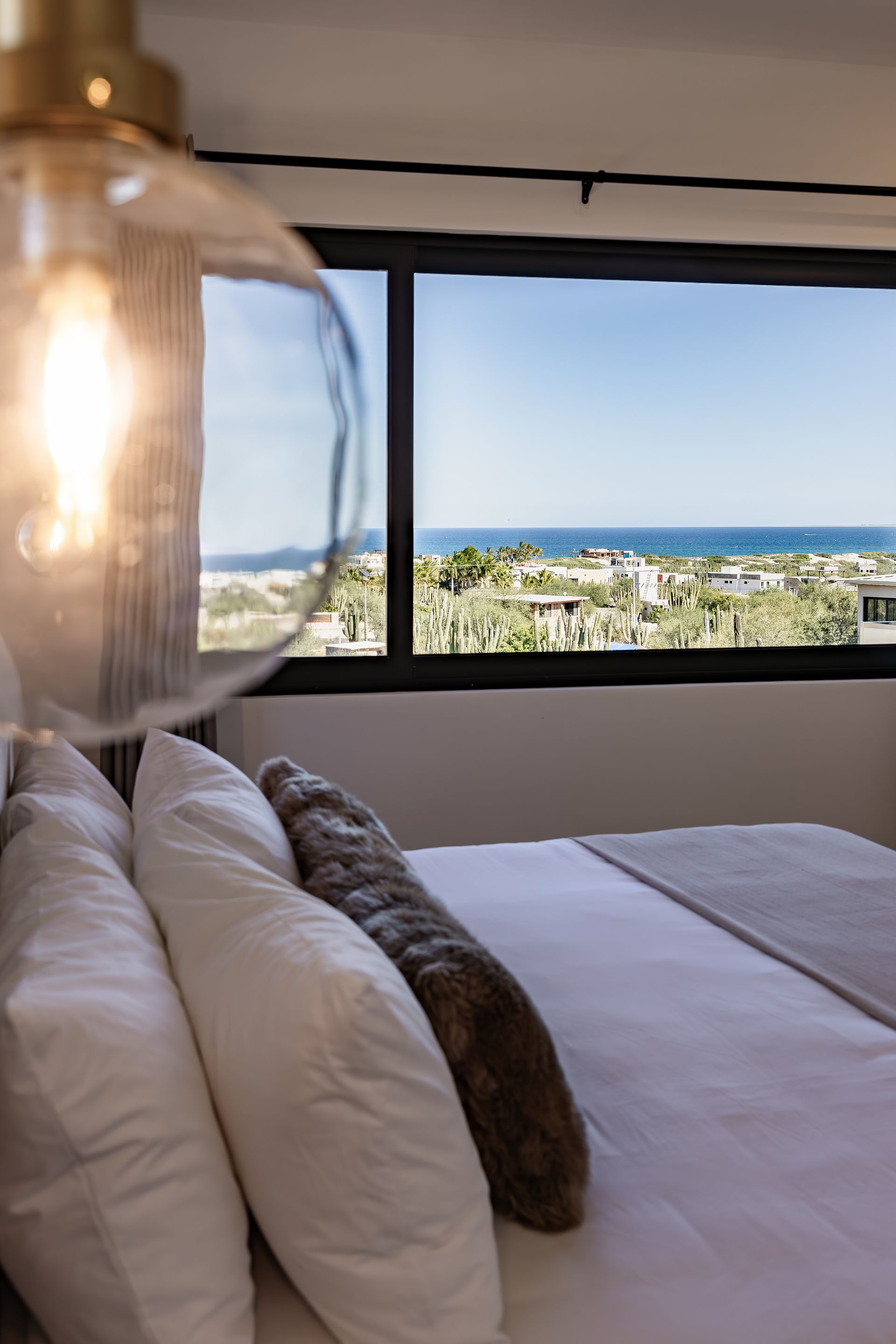Floor-to-ceiling windows framing panoramic Sea of Cortez views.