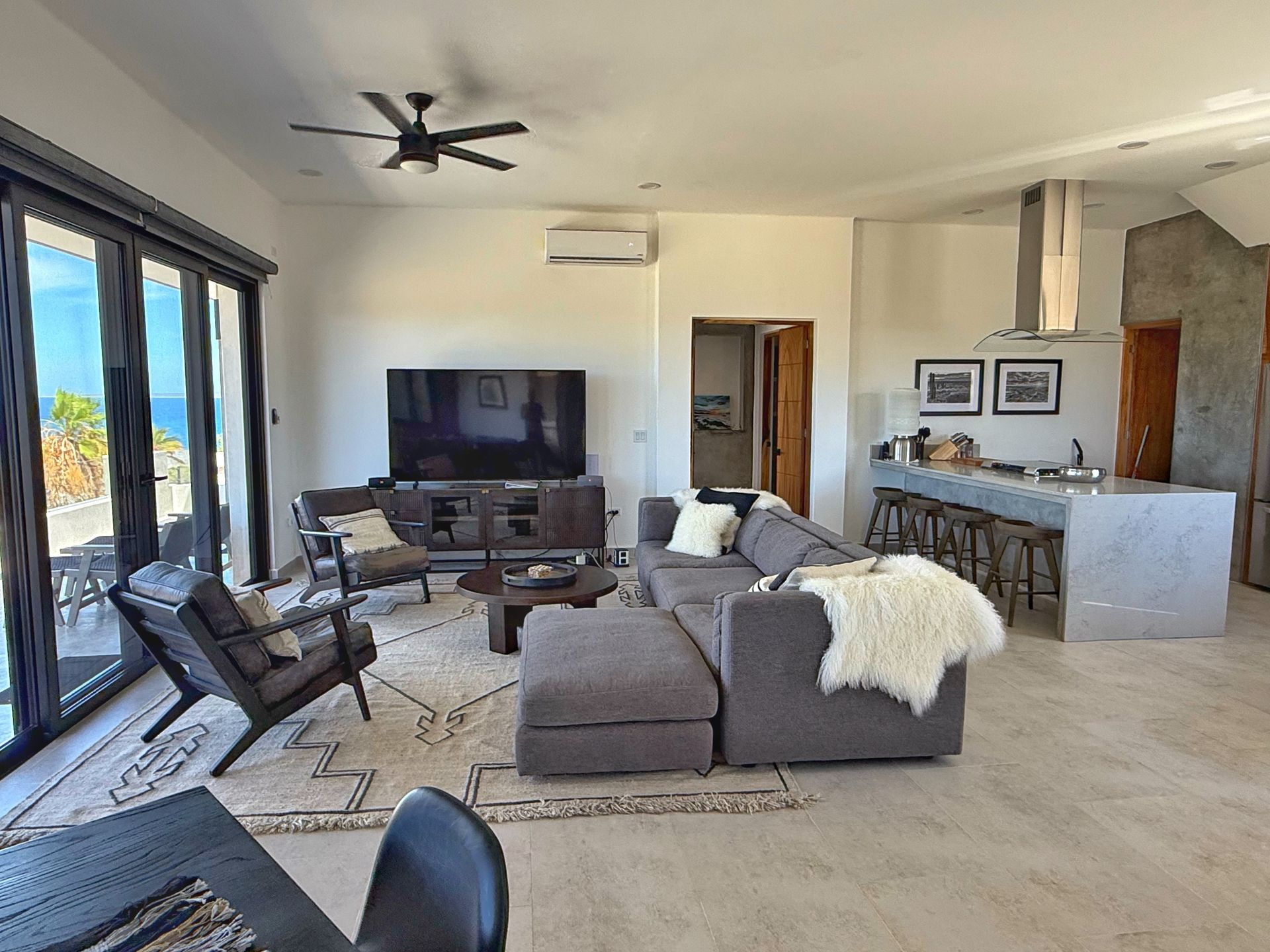 Elegant open-concept living room with panoramic ocean views.
