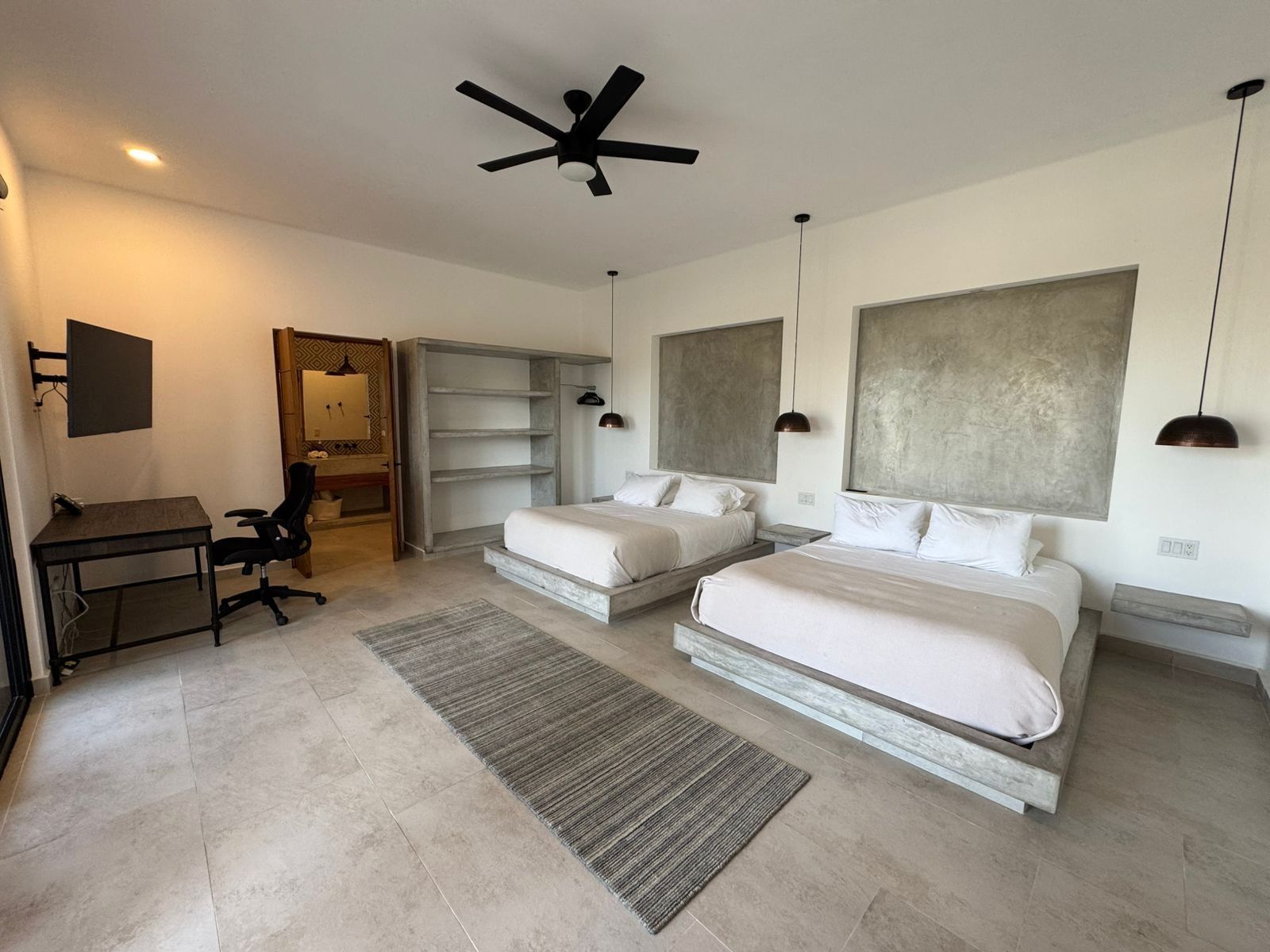 Spacious double queen bedroom in a modern minimalistic luxury villa.