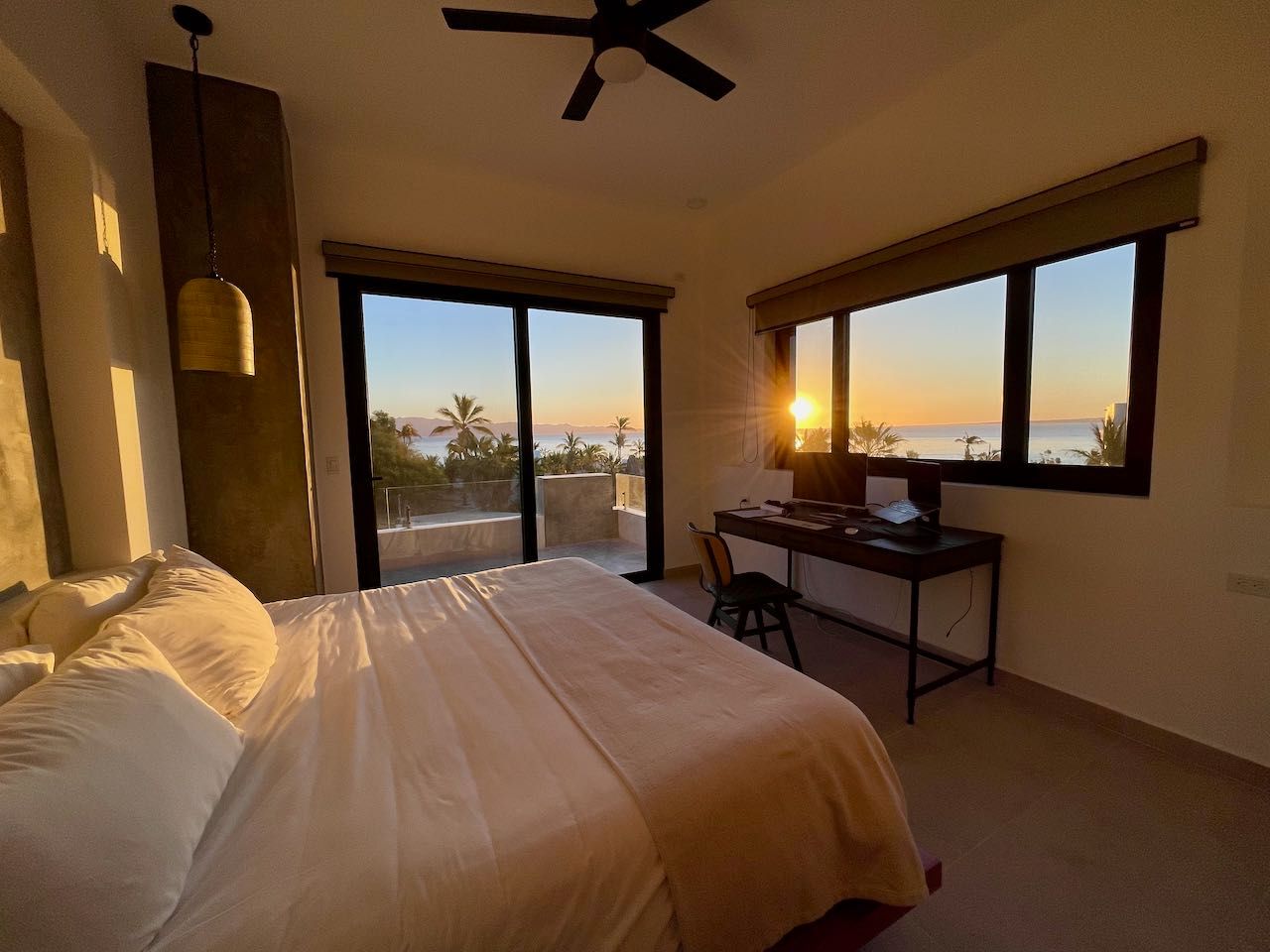 Luxury primary bedroom with sunrise views and contemporary design.