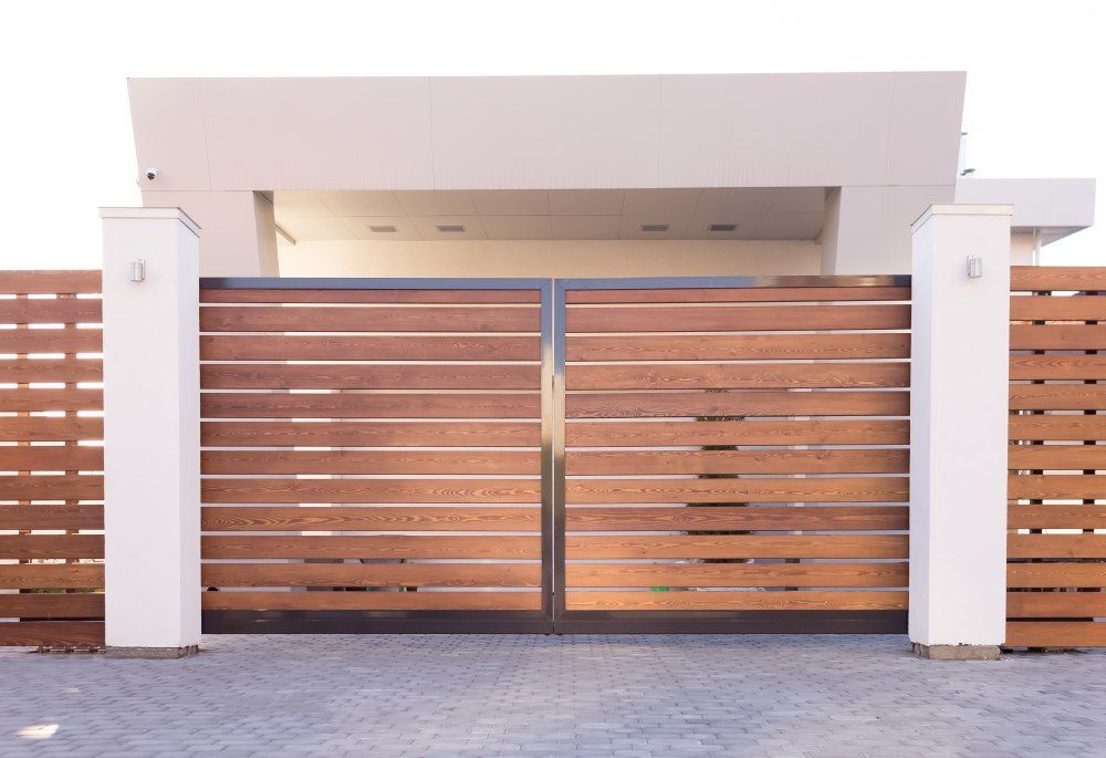 A White Building with A Wooden Gate in Front of It — Gold Coast Door Centre In Burleigh Heads, QLD
