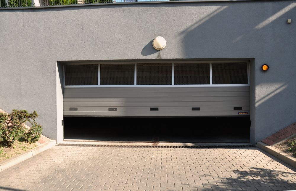 A Garage Door With A Light On Top Of It — Gold Coast Door Centre In Burleigh Heads, QLD