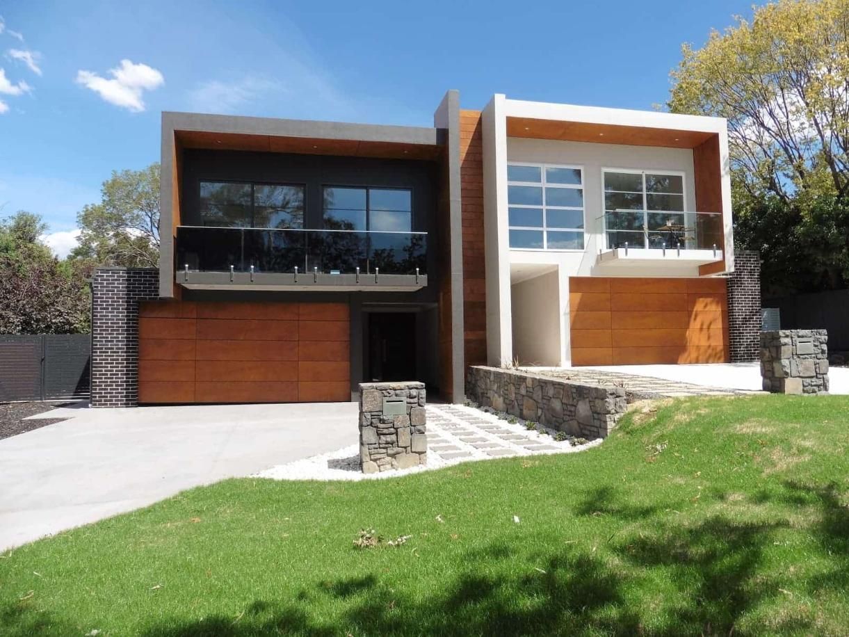 A Modern House With A Large Garage And Stairs — Gold Coast Door Centre In Burleigh Heads, QLD