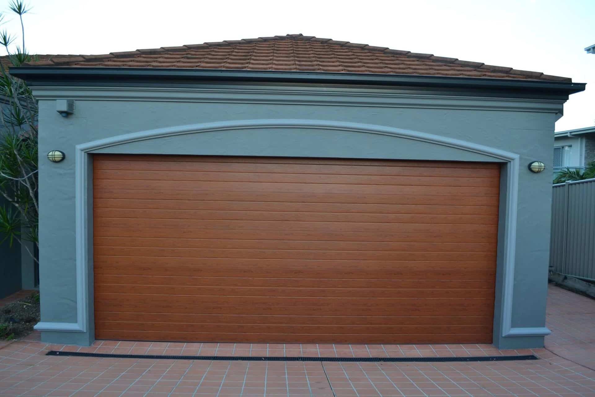 A Garage With A Wooden Garage Door And A Roof — Gold Coast Door Centre In Burleigh Heads, QLD