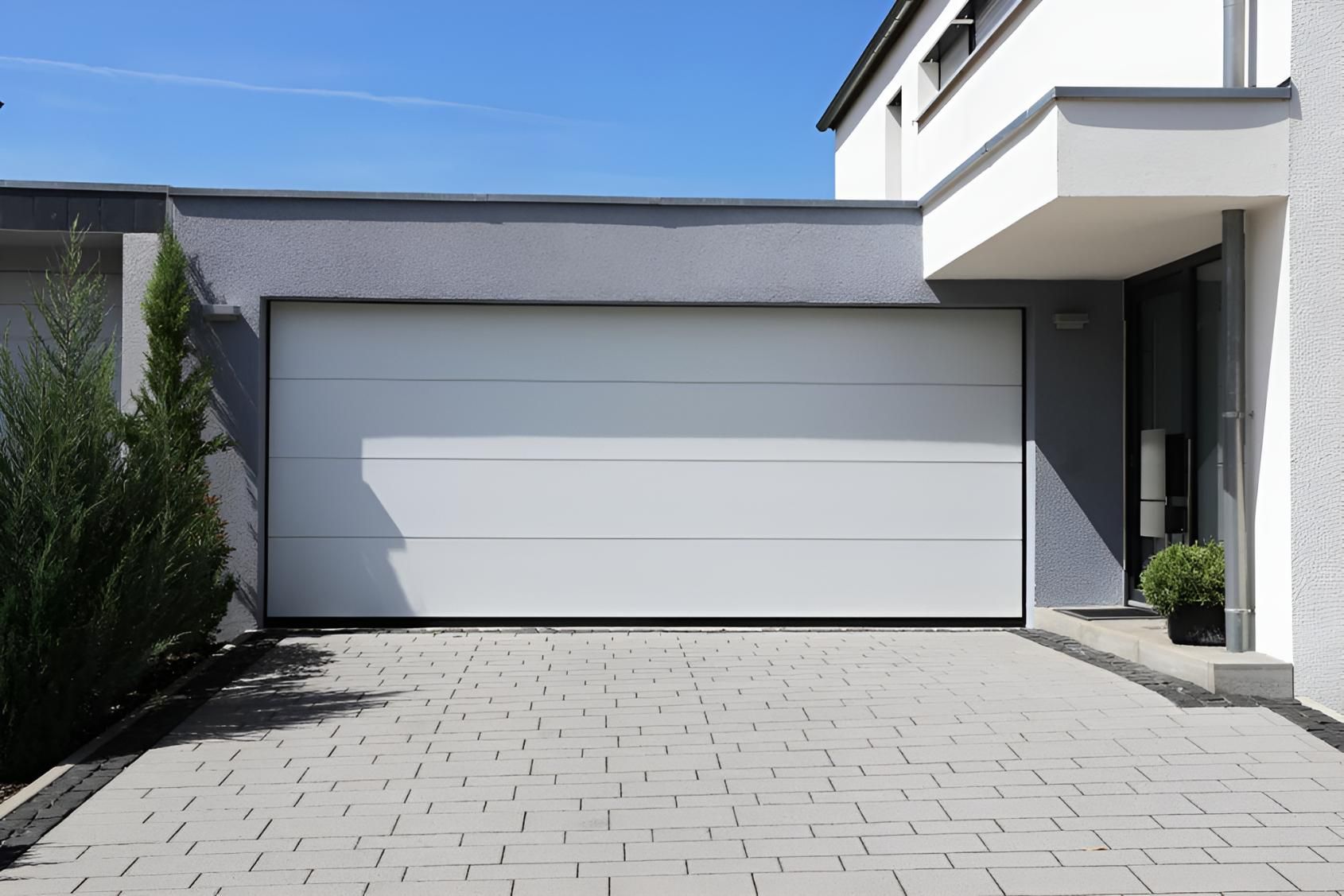 A White Garage Door Is Sitting In Front Of A Modern House — Gold Coast Door Centre In Burleigh Heads, QLD