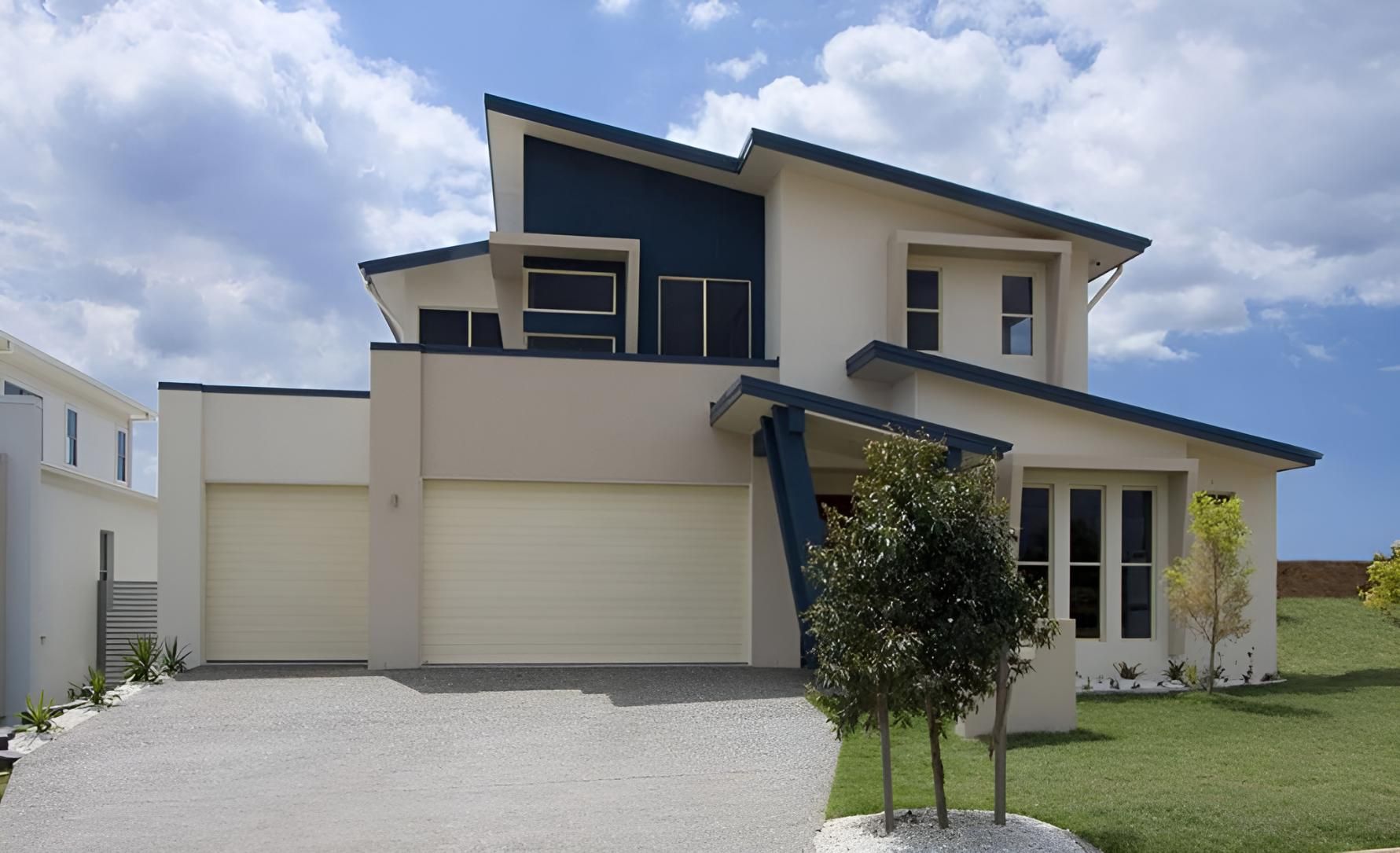 A White House with A Blue Roof and White Garage Doors — Gold Coast Door Centre In Burleigh Heads, QLD