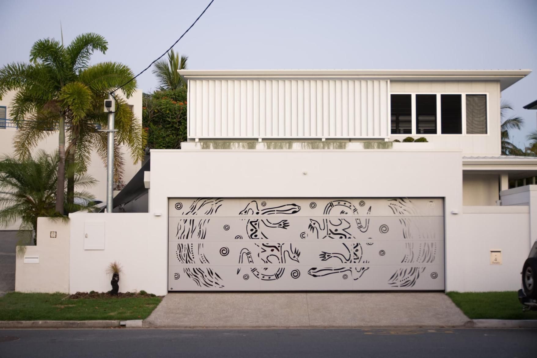 A White House With A Large White Garage Door — Gold Coast Door Centre In Burleigh Heads, QLD