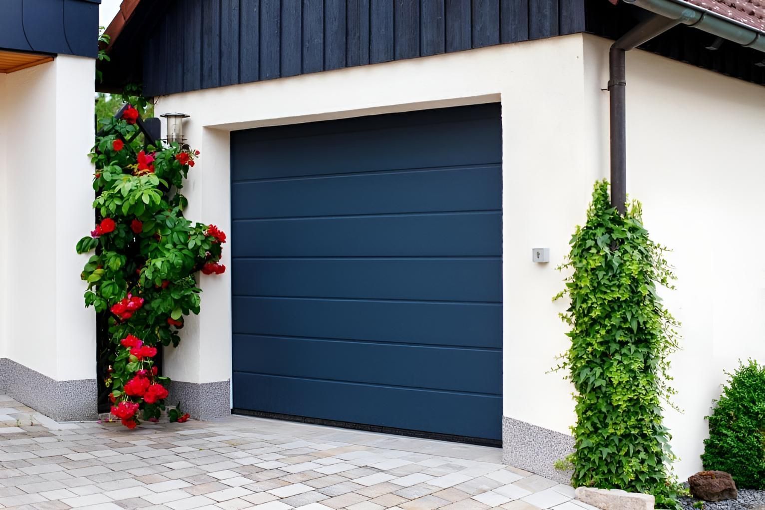 A Blue Garage Door Is In Front Of A White House — Gold Coast Door Centre In Burleigh Heads, QLD