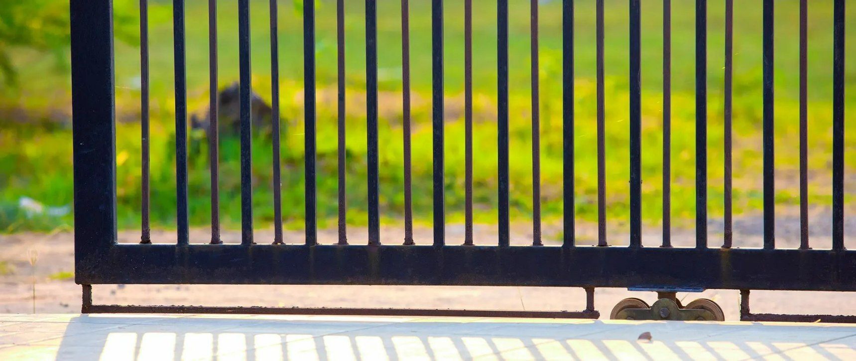 A Sliding Gate Is Open to A Grassy Field — Gold Coast Door Centre In Burleigh Heads, QLD