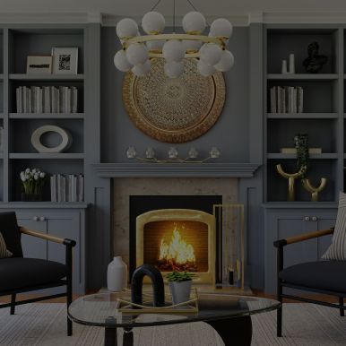 A living room with a fireplace , chairs , a coffee table and a chandelier.