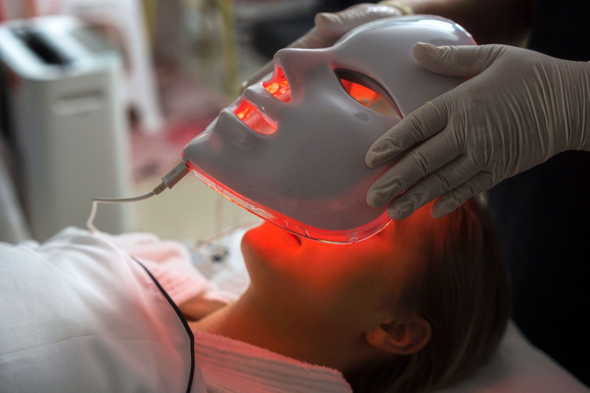 Woman Getting LED Mask Regenerative Treatment — Saginaw, MI — Barry, Ronald C MD Woman Getting LED Mask Regenerative Treatment — Saginaw, MI — Barry, Ronald C MD