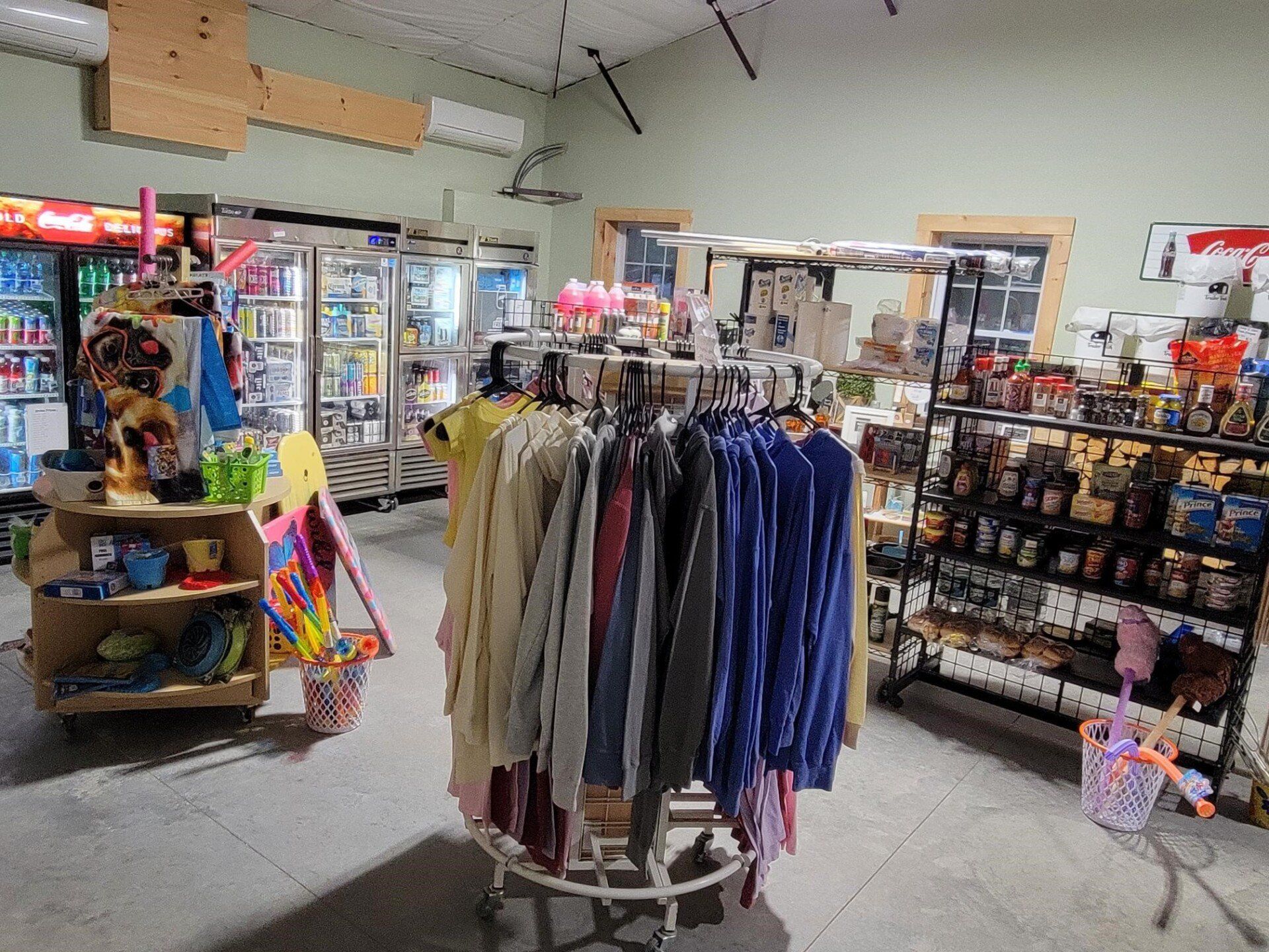 Clothing racks and shelves in a brightly lit thrift store aisle