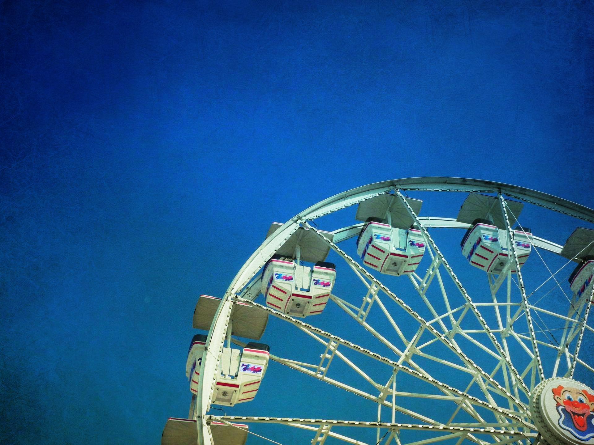 A ferris wheel with a blue sky in the background