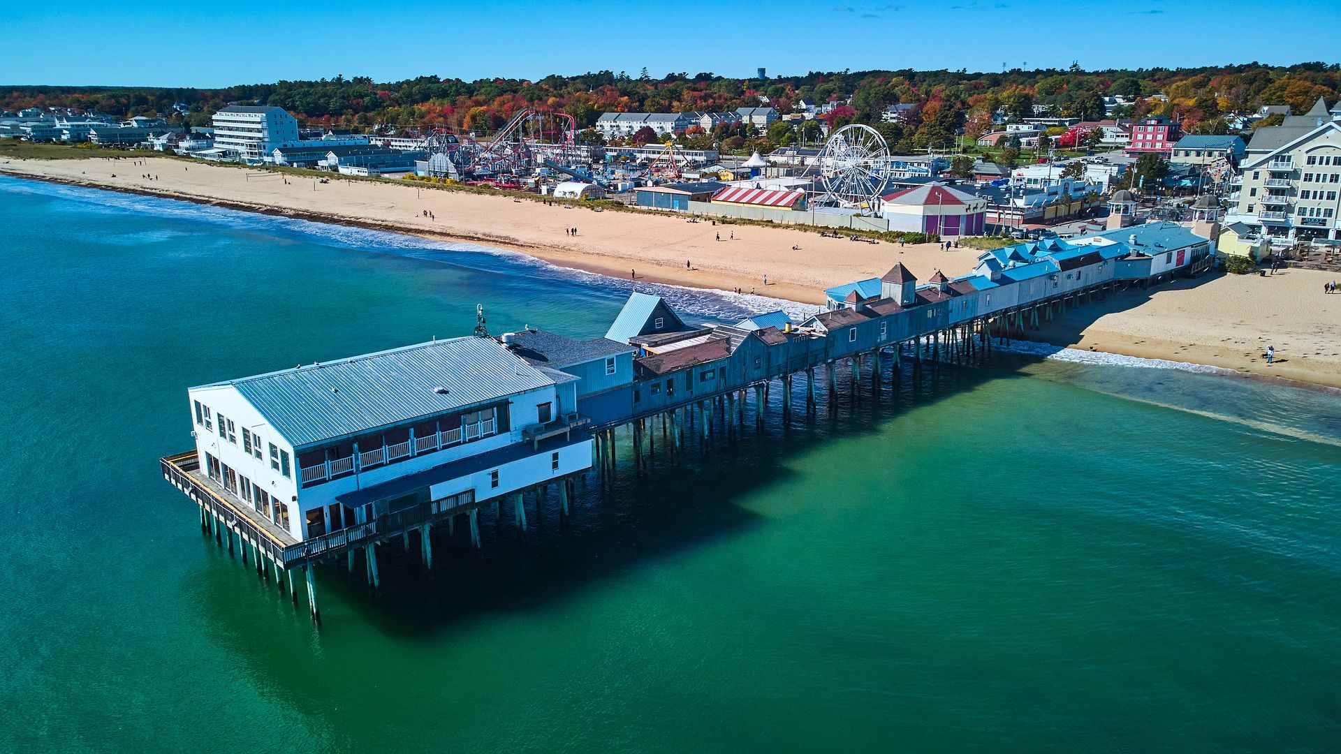 An aerial view of a pier sitting on top of a body of water.