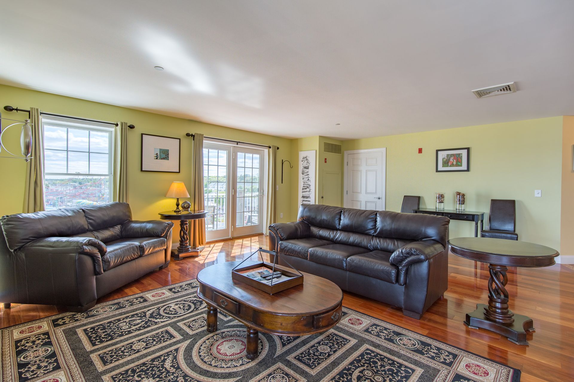 A living room with two couches , a table , and a rug.