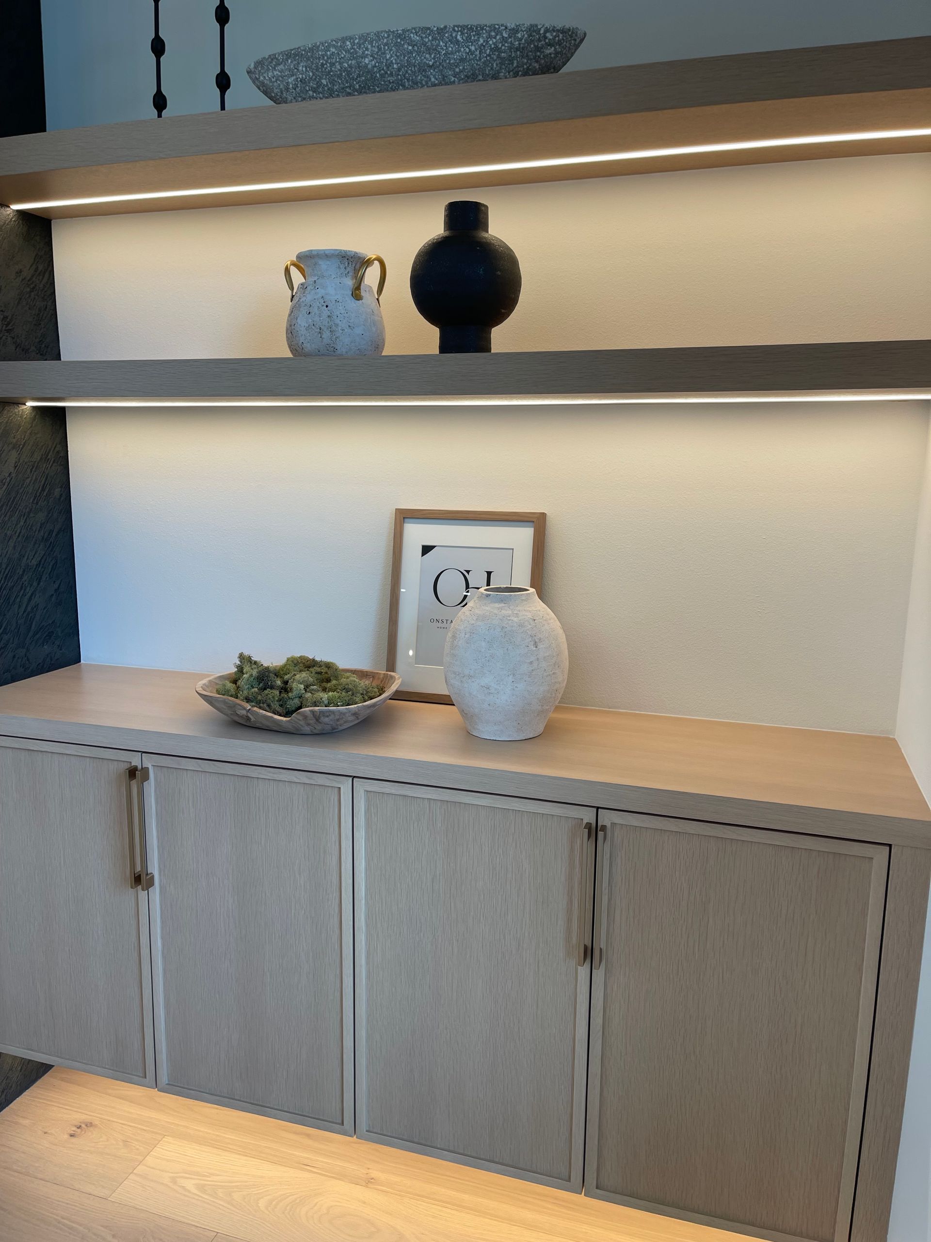 Built-in wood cabinet with shelves, decor, and warm under-shelf lighting in Portland, Oregon, WA