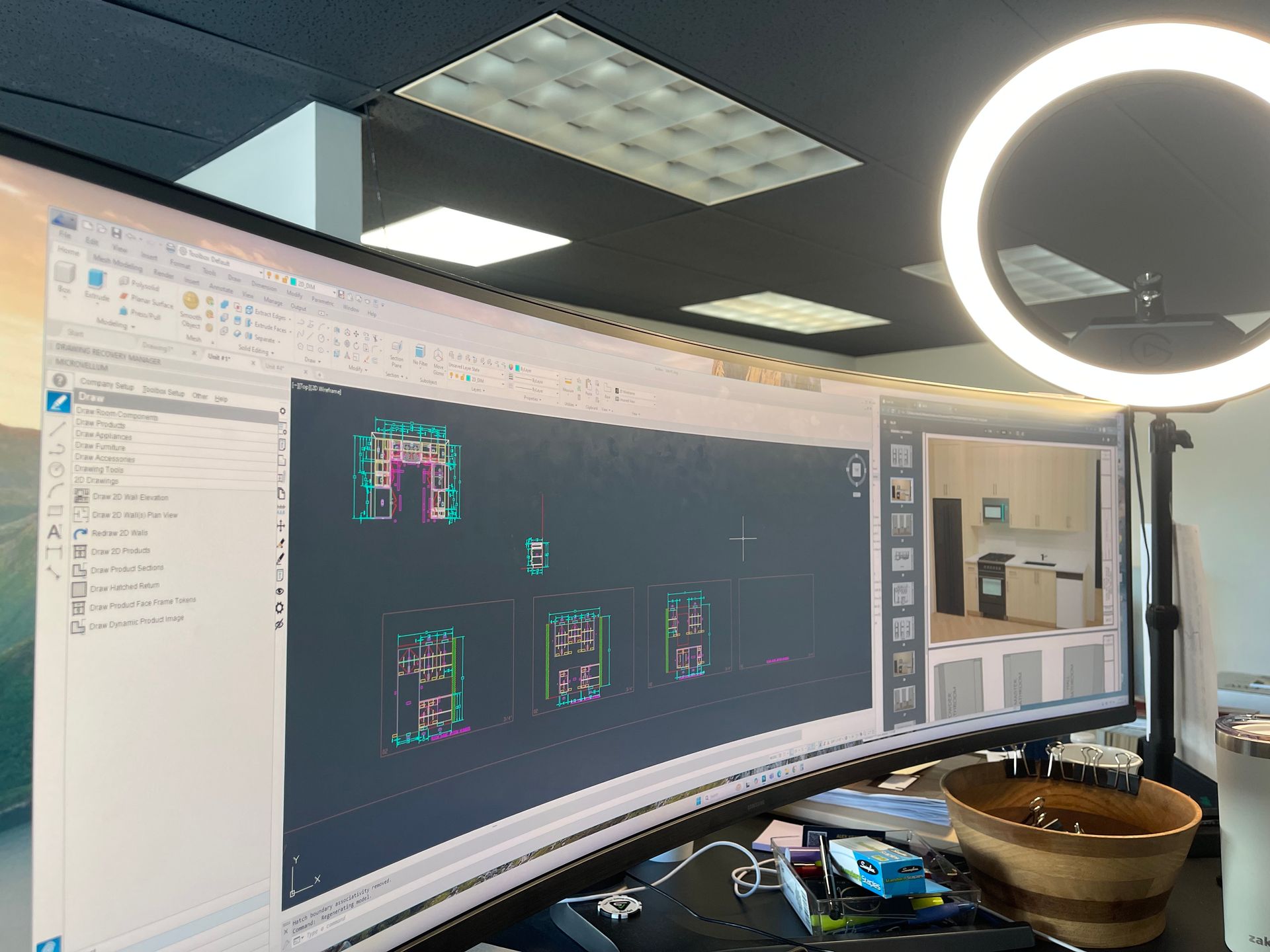 Curved monitor displaying architectural designs, with a ring light and office setting.