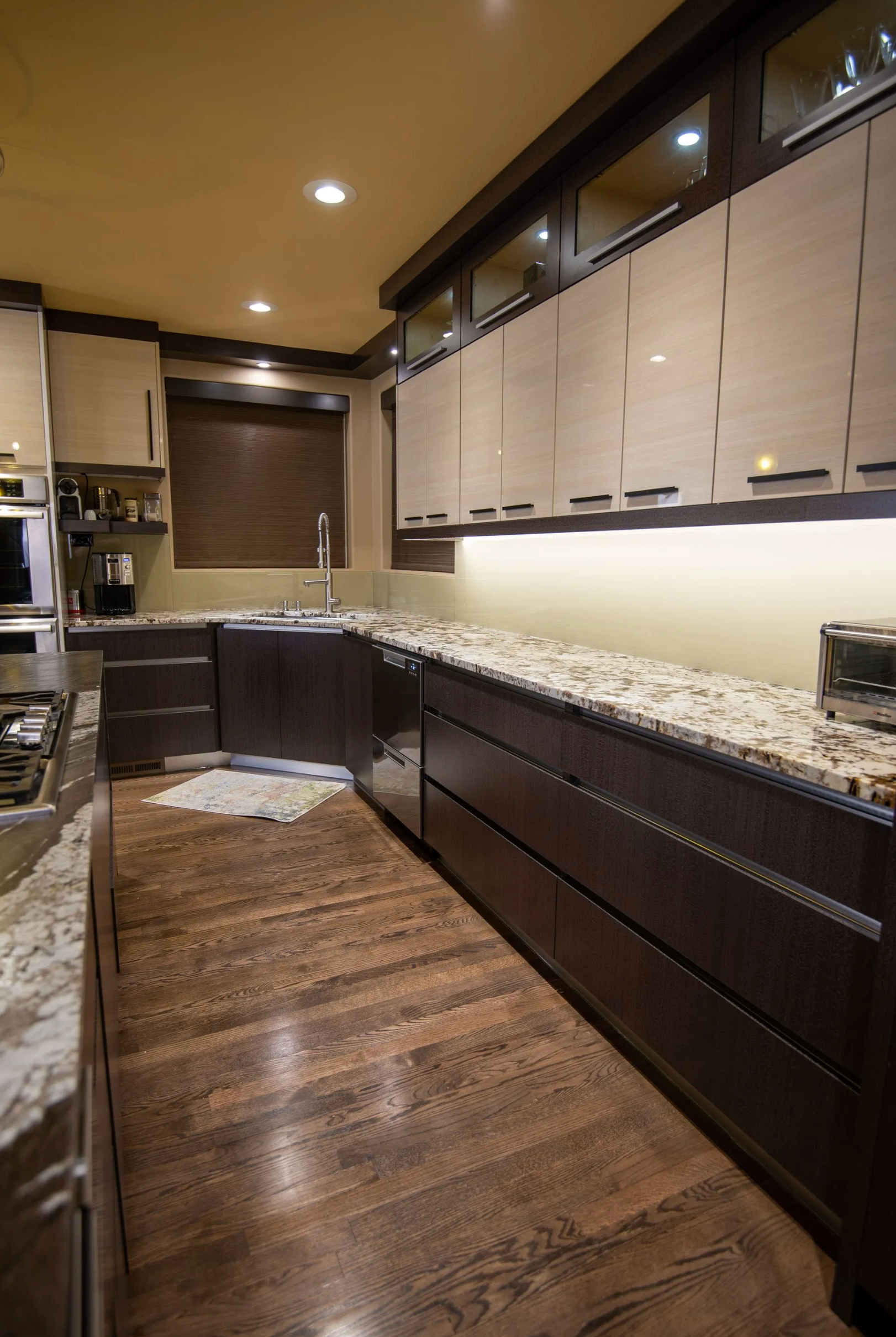 Modern dark cabinets with marble countertops and flat-panel design in Portland
