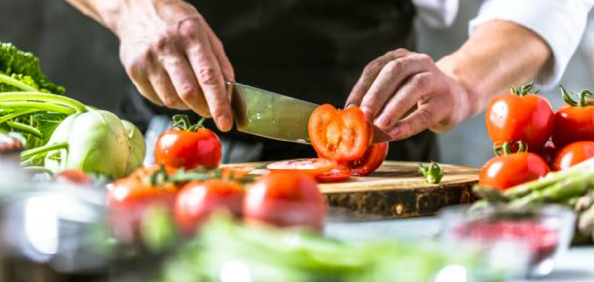Close-up of hands chopping vegetables — kitchen prep and cooking inspiration