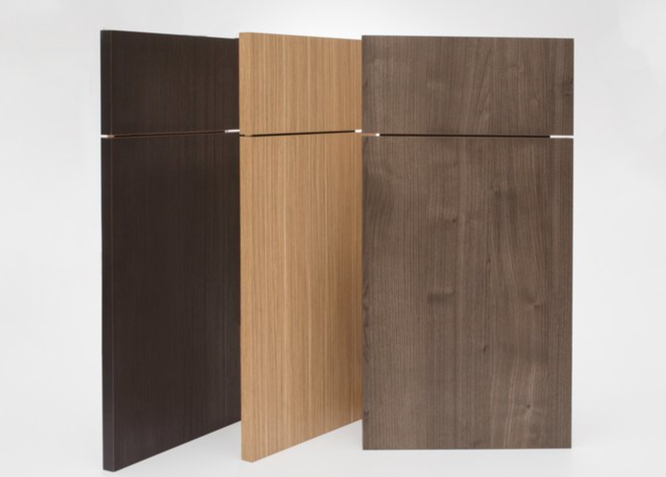 Cabinet door samples in various wood tones — choosing kitchen finishes