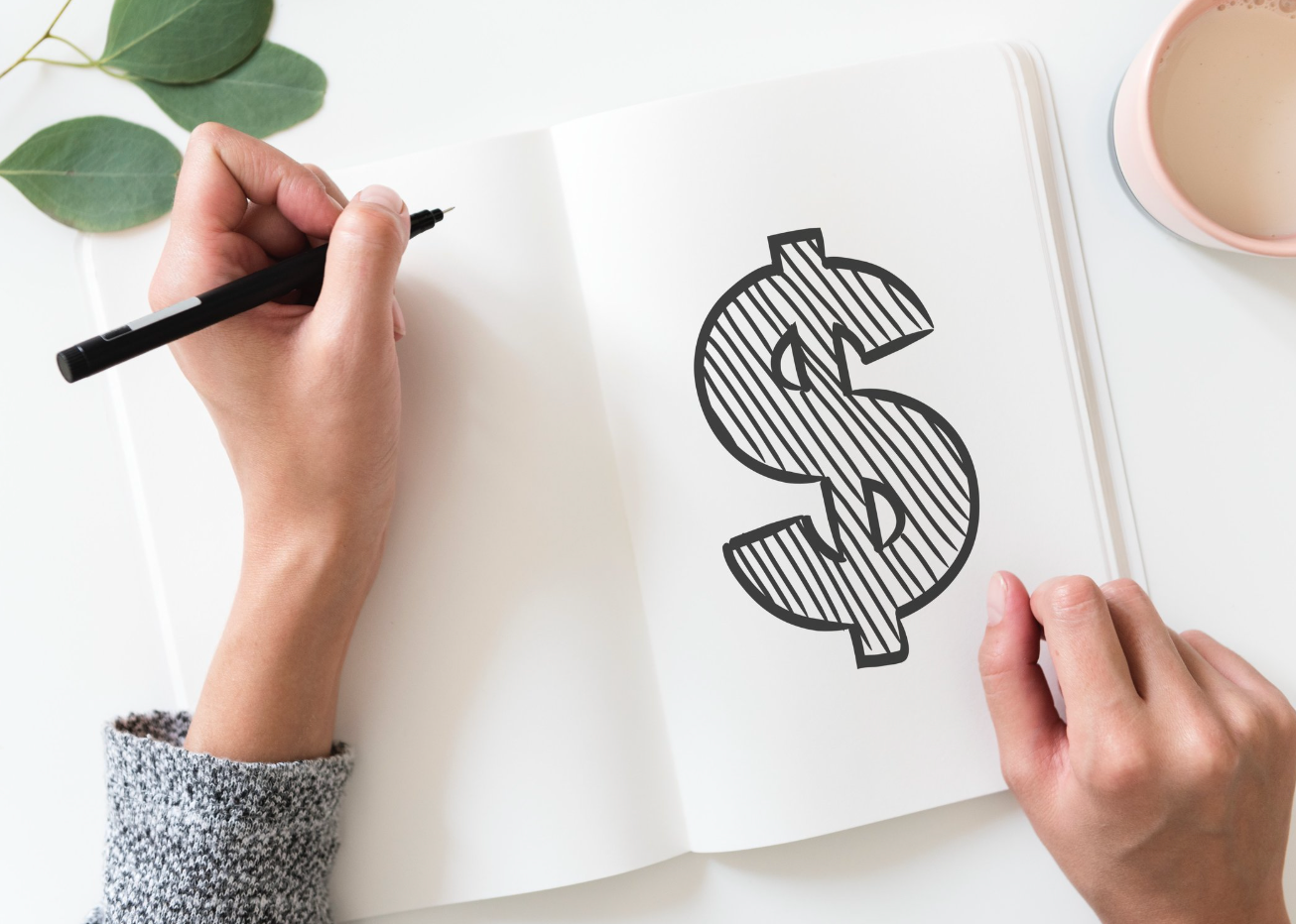 Hand drawing a dollar sign — kitchen budgeting or cost planning concept from Pro-Tech Woodworking