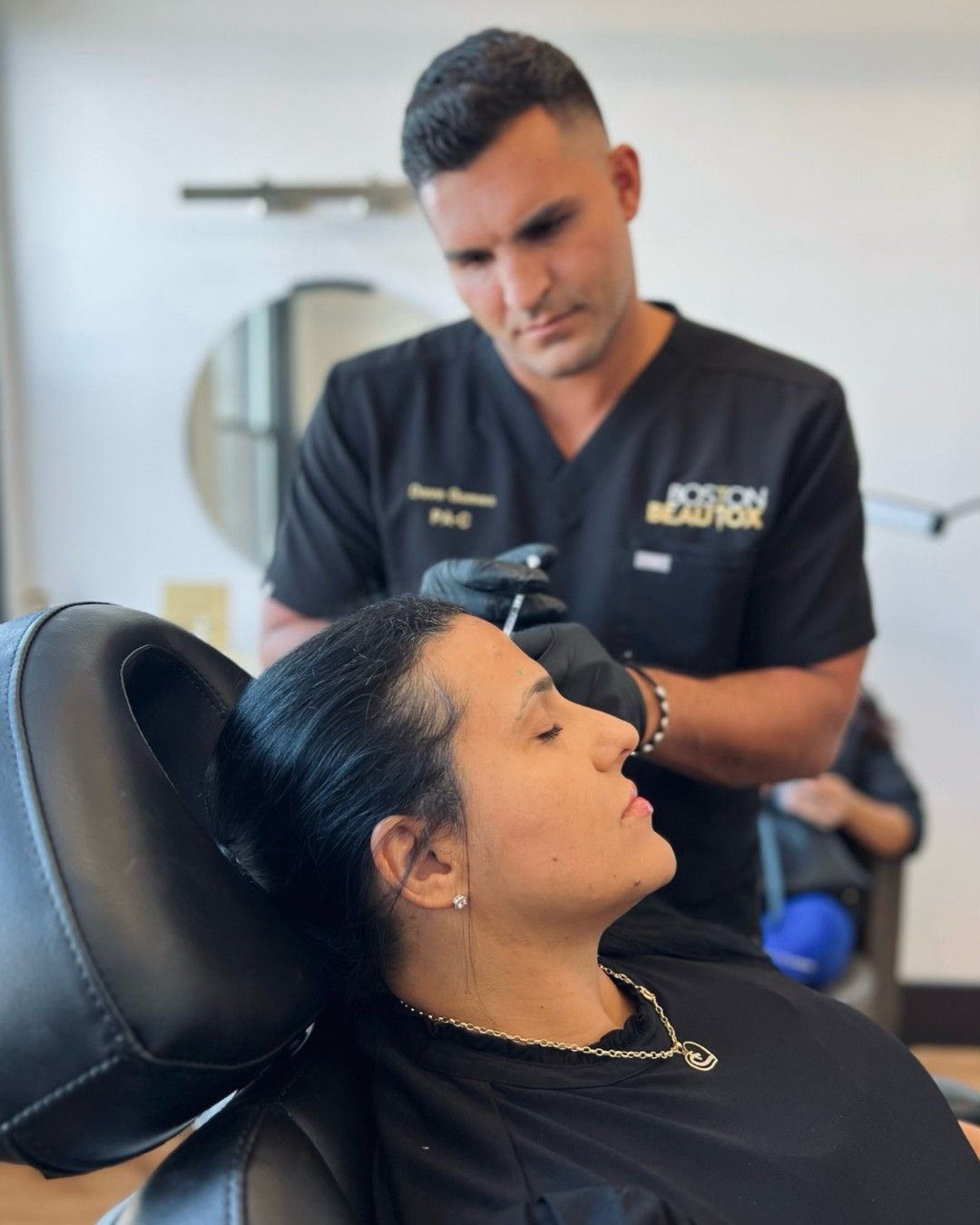 Doctor injecting a patient's forehead at a Boston Beautox.