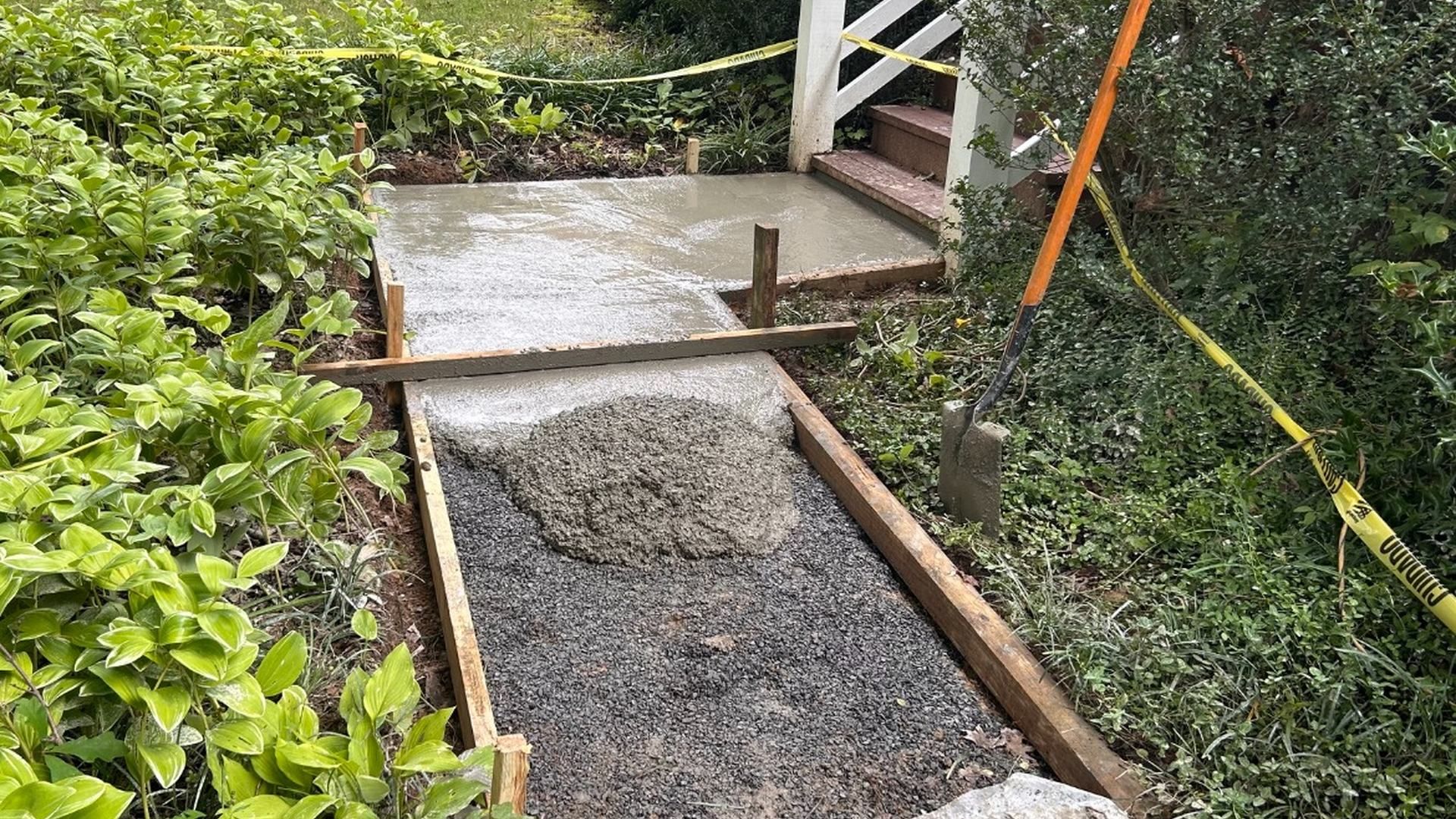 Freshly poured concrete walkway installed by Tayeb's Landscaping in Chesterfield, VA