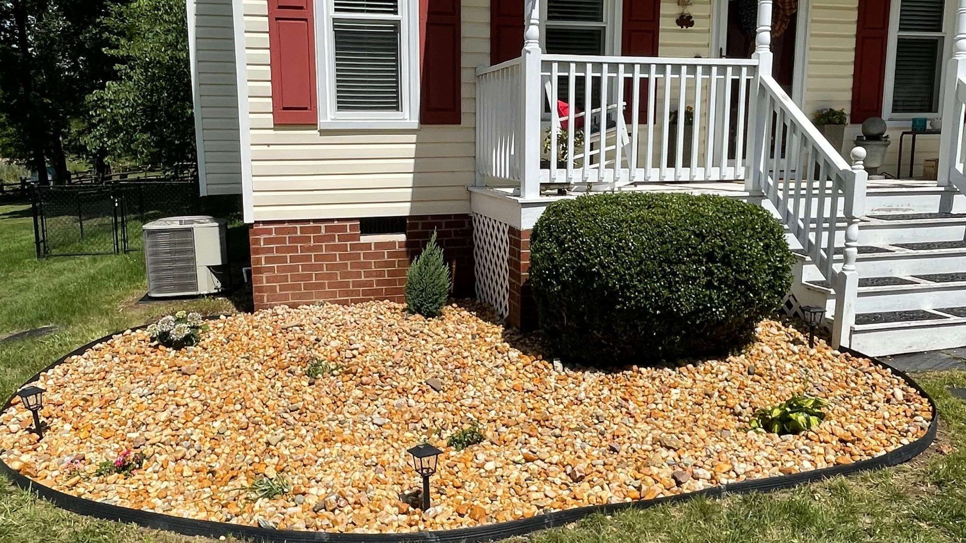 Decorative river rock landscape bed installed by Tayeb's Landscaping in Chesterfield, VA.
