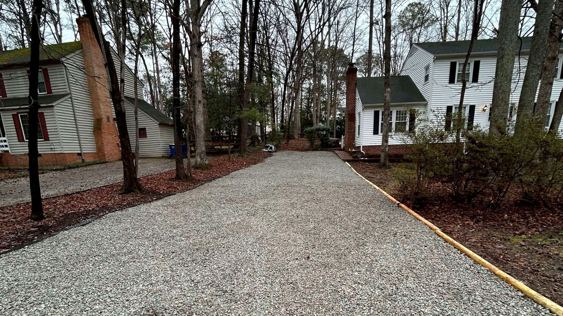 Newly resurfaced gravel driveway with fresh stone installed by Tayeb Landscaping in Chesterfield, VA.