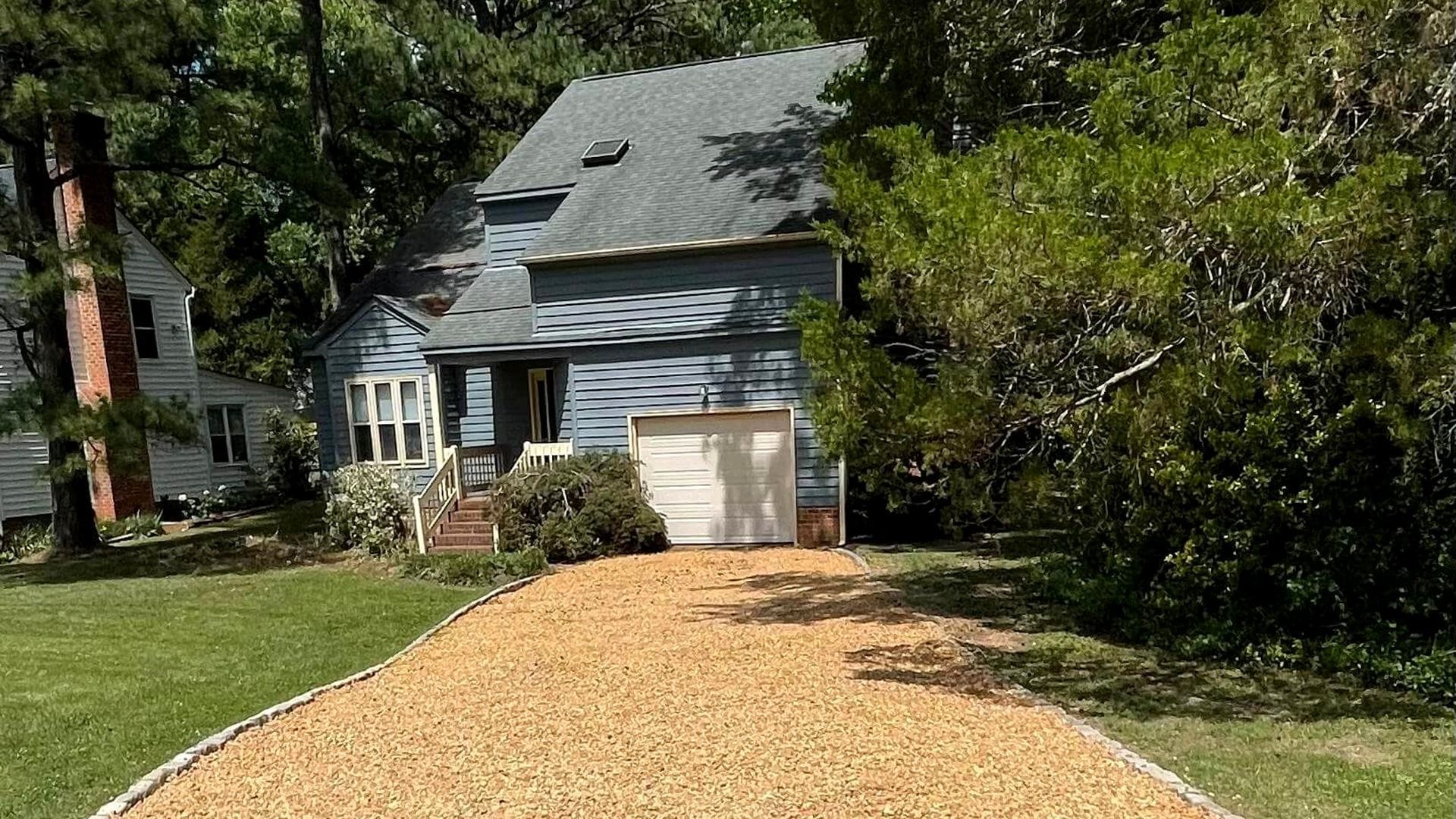 Newly resurfaced gravel driveway with fresh stone installation in Chesterfield, VA.